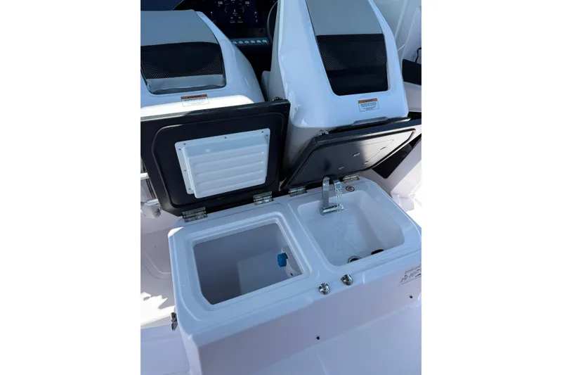 Slide: The Image of 2025 Axopar 29 Sun-Top boat interior with open storage and sink. - 25