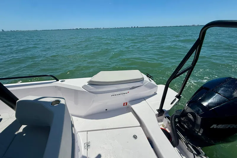 Slide: The Image of 2025 Axopar 29 Sun-Top boat on water, featuring sleek design and powerful engine. - 5