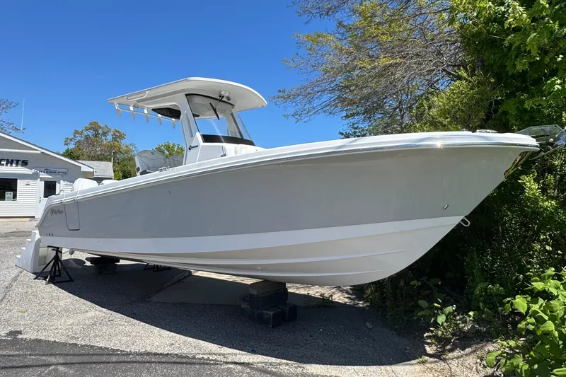 The Image of 2026 Edgewater 262CC boat displayed outdoors on a sunny day. - 0