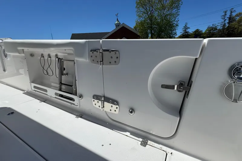Slide: The Image of 2026 Edgewater 262CC boat interior, featuring storage compartments and stainless steel hardware. - 12