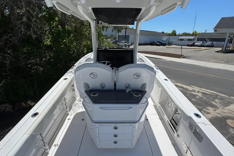Slide: The Image of 2026 Edgewater 262CC boat interior with dual helm seats and console, docked outdoors. - 14