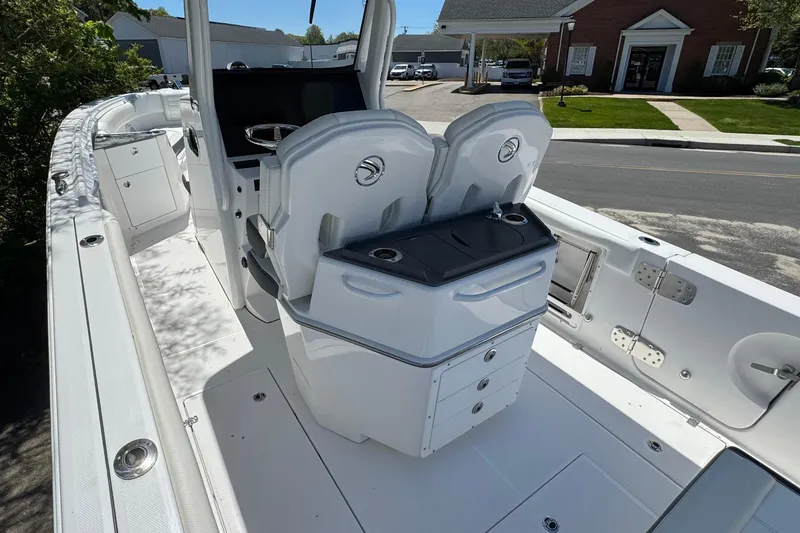 Slide: The Image of 2026 Edgewater 262CC boat interior with dual seats and storage compartments. - 16