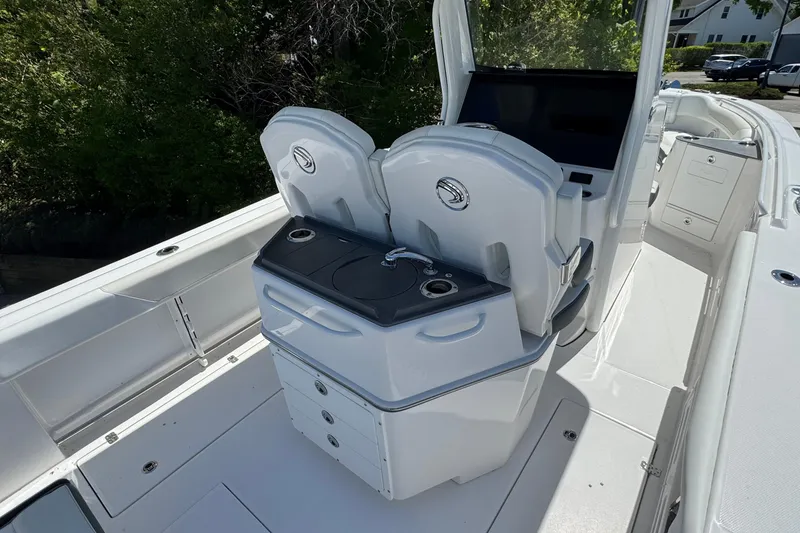 Slide: The Image of 2026 Edgewater 262CC boat interior with dual helm seats and storage compartments. - 18