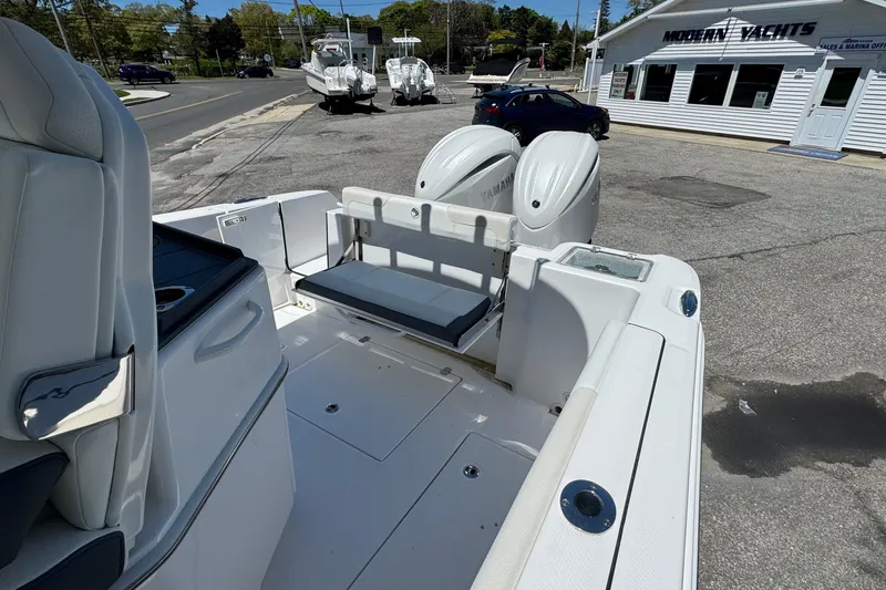 Slide: The Image of 2026 Edgewater 262CC boat with dual Yamaha engines at marina dealership. - 19