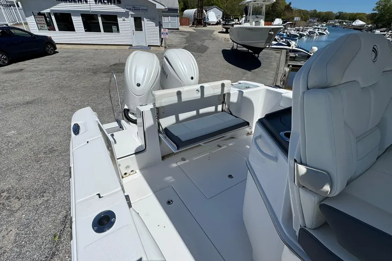 Slide: The Image of 2026 Edgewater 262CC boat interior with dual engines at marina. - 20