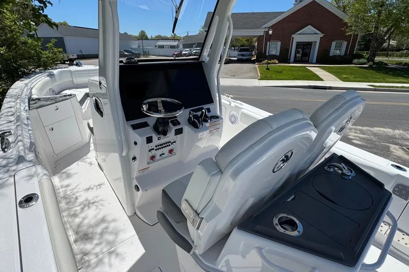 Slide: The Image of 2026 Edgewater 262CC boat interior with modern helm and seating. - 21