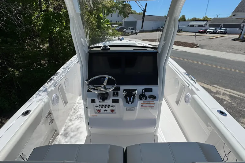 Slide: The Image of 2026 Edgewater 262CC boat cockpit with modern steering and control panel. - 22