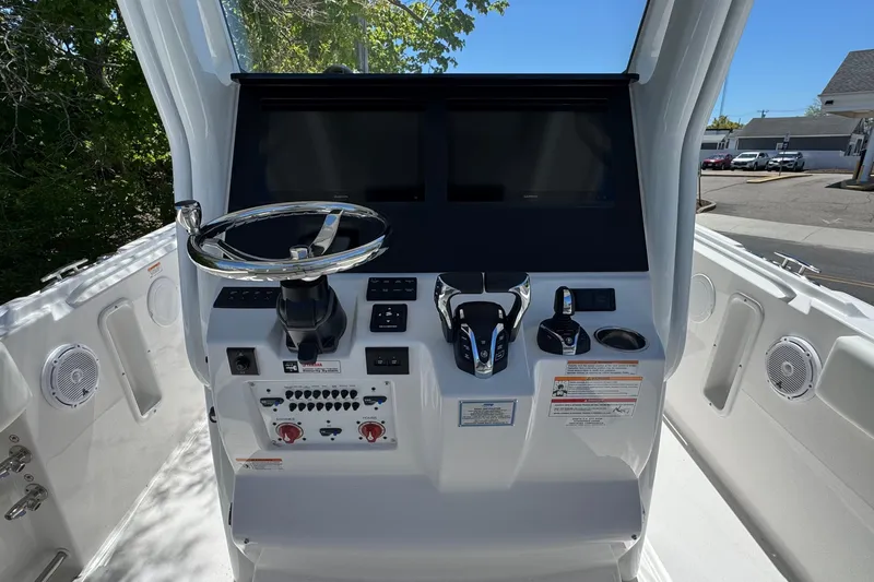 Slide: The Image of Edgewater 262CC 2026 boat console with steering wheel and controls. - 23