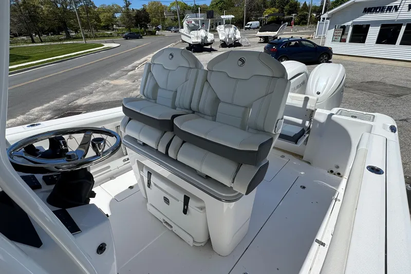 Slide: The Image of 2026 Edgewater 262CC boat interior with dual seats and steering wheel. - 25