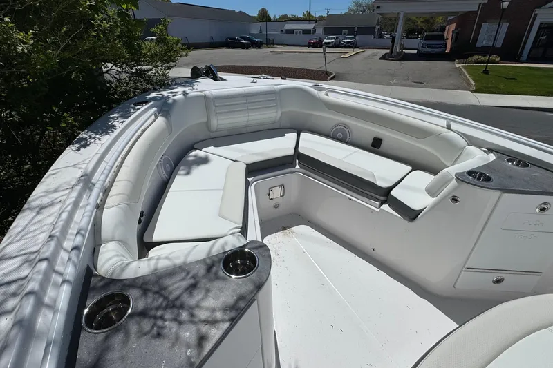 Slide: The Image of Interior view of 2026 Edgewater 262CC boat with white seating and cup holders. - 29