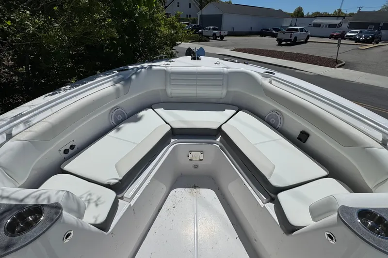 Slide: The Image of 2026 Edgewater 262CC boat interior with white cushioned seating and cup holders. - 30