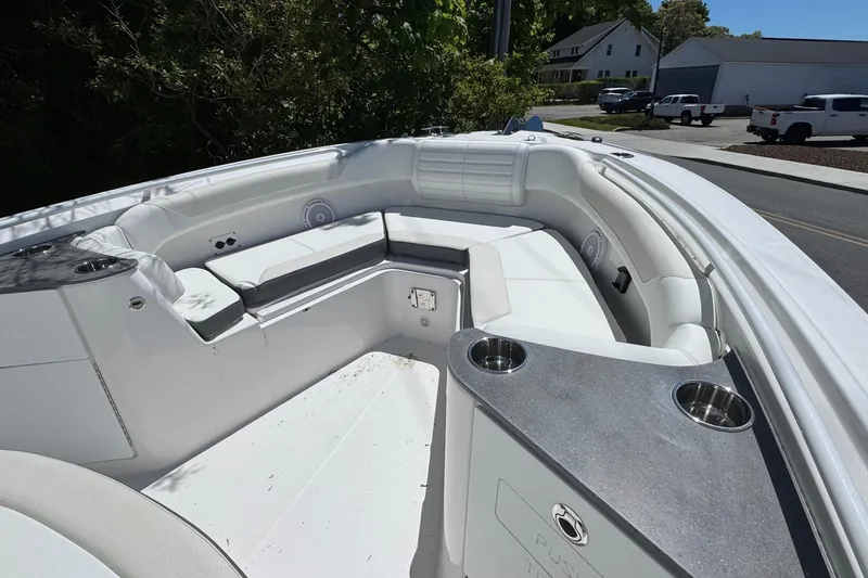 Slide: The Image of 2026 Edgewater 262CC boat interior with white seating and cup holders. - 33