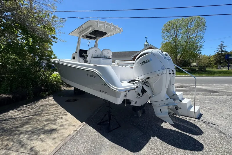 Slide: The Image of 2026 Edgewater 262CC boat with Yamaha engines, parked outdoors on a sunny day. - 4