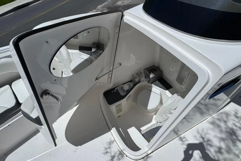 Slide: The Image of Interior view of 2026 Edgewater 262CC boat's compact bathroom with toilet and mirror. - 42