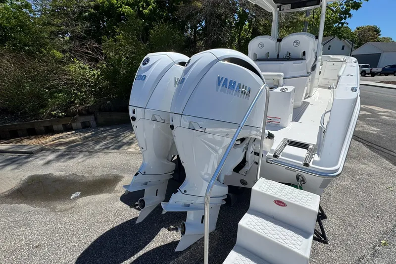 Slide: The Image of 2026 Edgewater 262CC boat with twin Yamaha outboard engines, parked on a sunny day. - 5