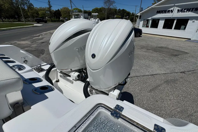 Slide: The Image of 2026 Edgewater 262CC boat with dual Yamaha outboard engines at Modern Yachts dealership. - 7