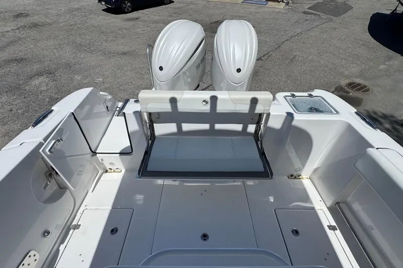 Slide: The Image of 2026 Edgewater 262CC boat interior with dual engines and seating area. - 9