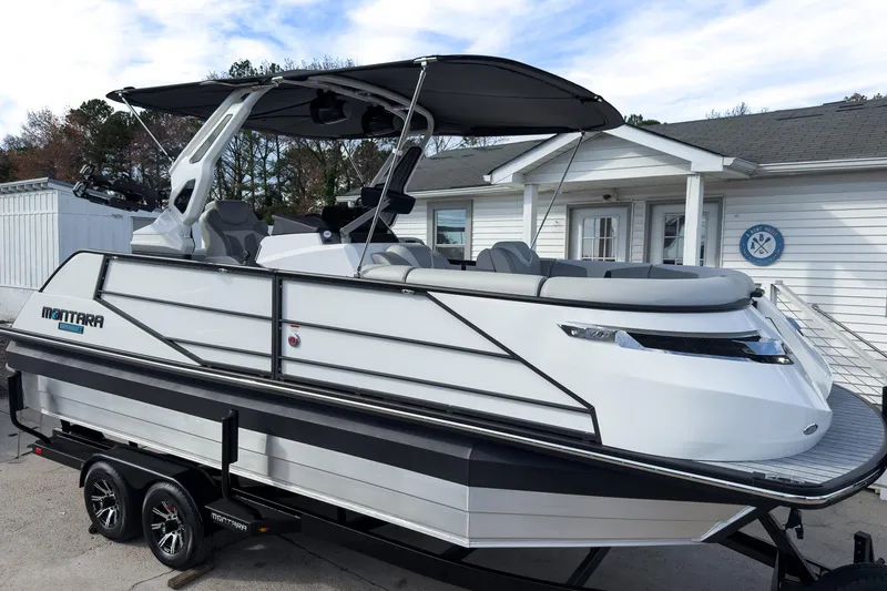 The Image of 2026 Montara Surf Boss 2.0 SL 23" boat on trailer, parked outside a building. - 0