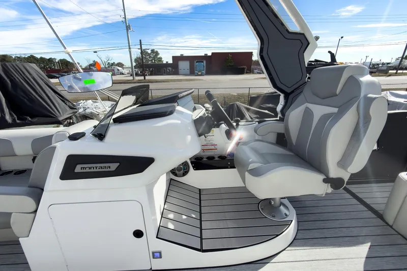 Slide: The Image of 2026 Montara Surf Boss 2.0 SL 23" boat interior with modern helm and seating. - 13