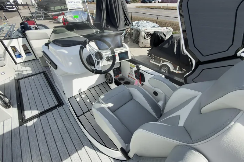 Slide: The Image of Interior of 2026 Montara Surf Boss 2.0 SL 23" boat, featuring modern helm and seating. - 14