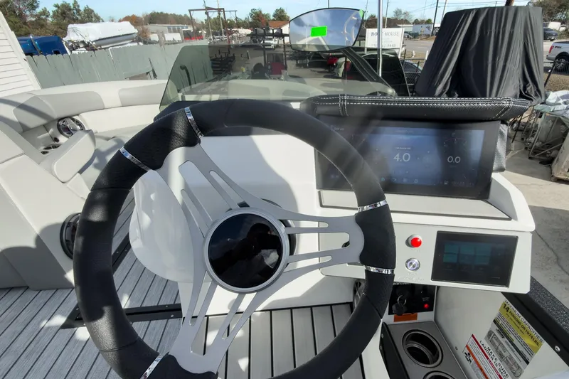 Slide: The Image of 2026 Montara Surf Boss 2.0 SL 23" boat dashboard with steering wheel and digital display. - 15