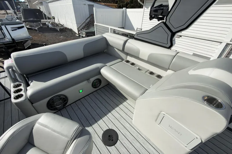 Slide: The Image of 2026 Montara Surf Boss 2.0 SL 23" boat interior with gray seating and cup holders. - 18
