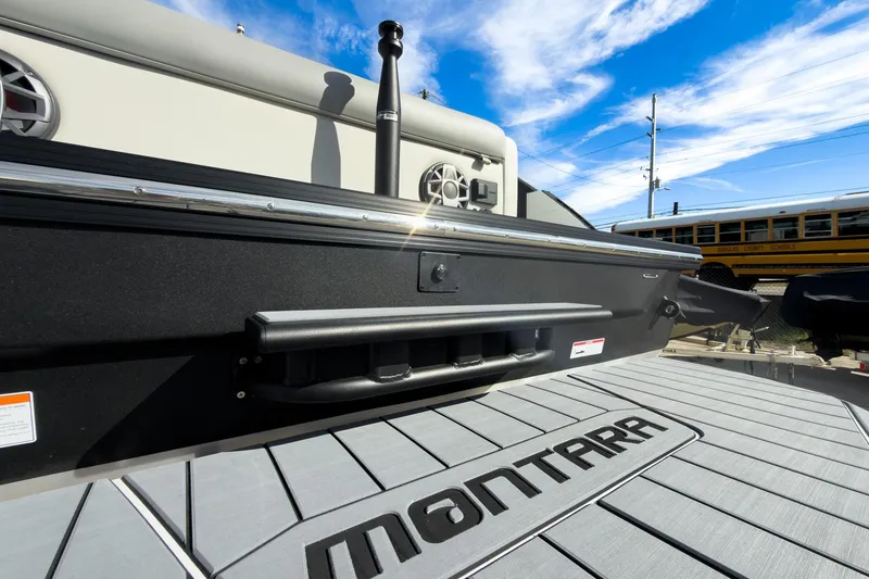 Slide: The Image of 2026 Montara Surf Boss 2.0 SL 23" boat deck with logo, under a clear blue sky. - 23