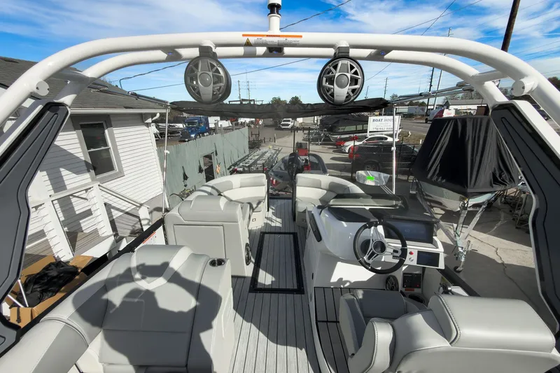 Slide: The Image of 2026 Montara Surf Boss 2.0 SL 23" boat interior with modern seating and steering wheel. - 26