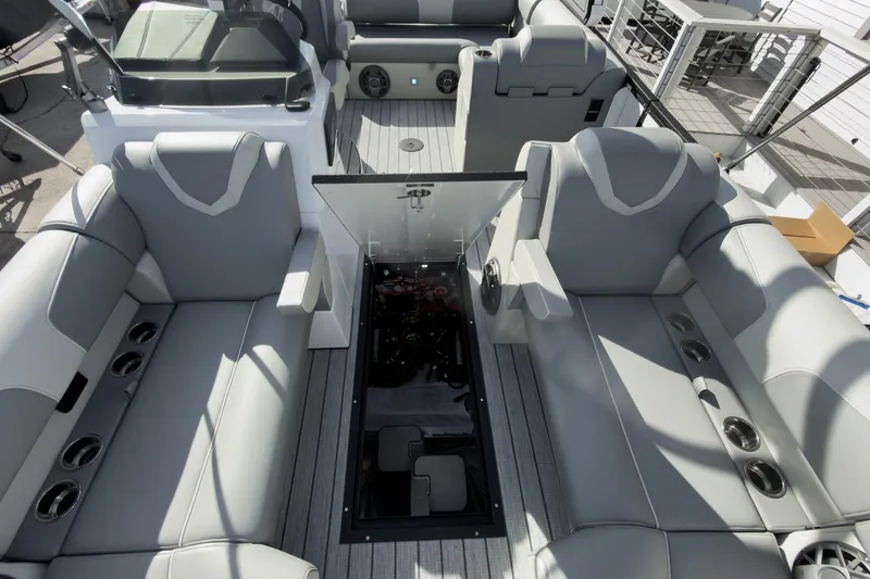 Slide: The Image of 2026 Montara Surf Boss 2.0 SL 23" boat interior with gray seating and open engine compartment. - 32