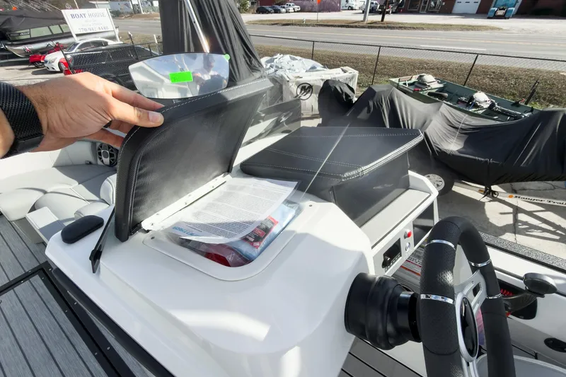 Slide: The Image of 2026 Montara Surf Boss 2.0 SL 23" boat dashboard with storage compartment open. - 35