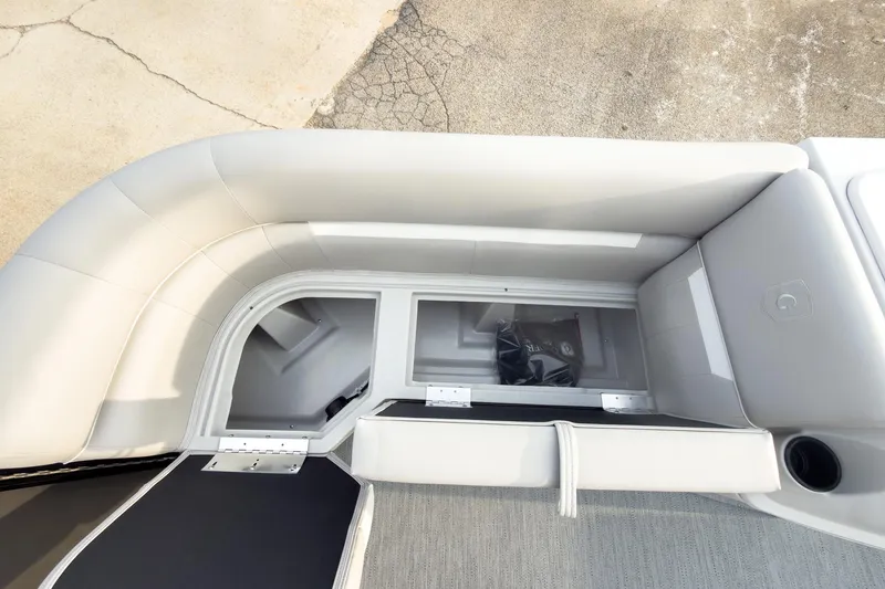 Slide: The Image of 2026 Godfrey Sweetwater Xperience 22' Tritoon storage compartment with flip lounge seating. - 11