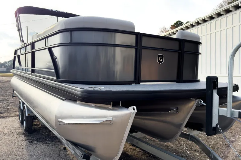 Slide: The Image of 2026 Godfrey Sweetwater Xperience 22' Tritoon boat on trailer, side view. - 2