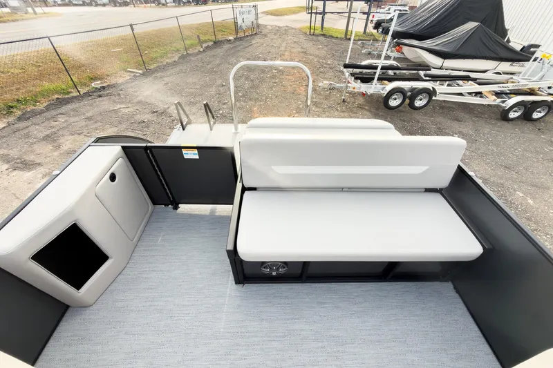 Slide: The Image of 2026 Godfrey Sweetwater Xperience 22' Tritoon with single flip lounge seating, docked outdoors. - 20