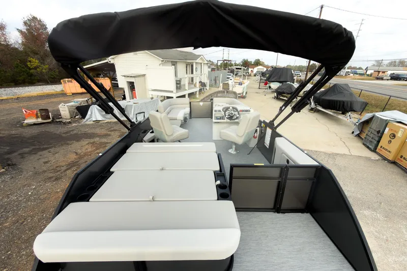 Slide: The Image of 2026 Godfrey Sweetwater Xperience 22' Tritoon with single flip lounge, docked outdoors. - 26