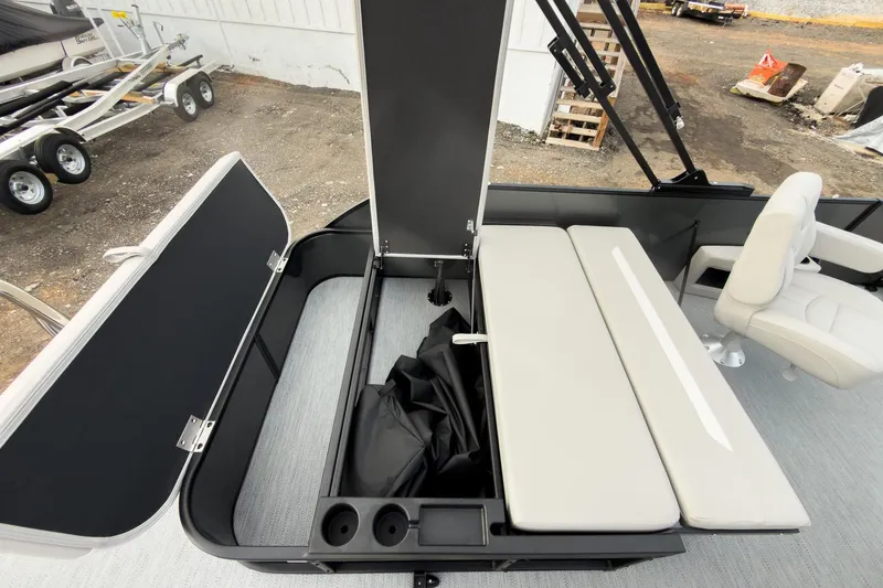 Slide: The Image of 2026 Godfrey Sweetwater Xperience 22' Tritoon with open storage compartment and seating area. - 28