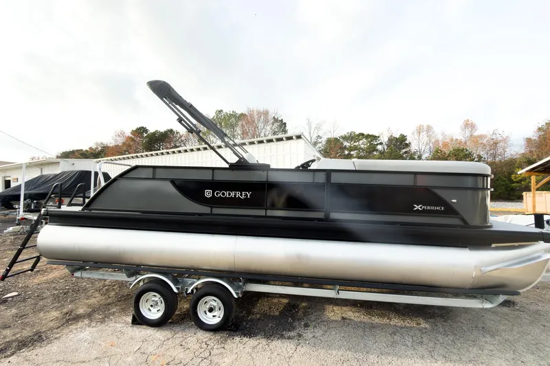 Slide: The Image of 2026 Godfrey Sweetwater Xperience 22' Tritoon boat on trailer, side view. - 3