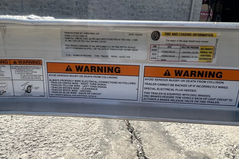 Slide: The Image of Warning labels and tire information on a 2026 Pioneer 222 Islander trailer. - 17