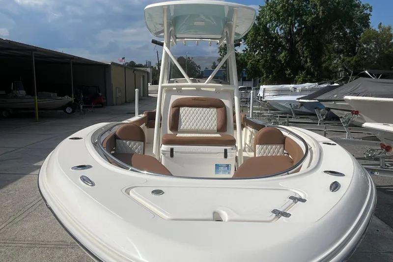 Slide: The Image of 2026 Pioneer 222 Islander boat with sleek design and comfortable seating in a marina setting. - 18