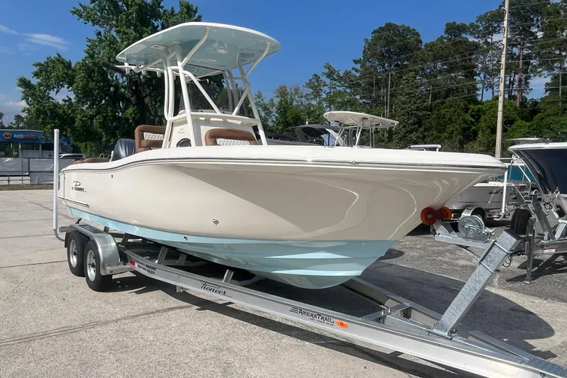Slide: The Image of 2026 Pioneer 222 Islander boat on trailer, parked outdoors, showcasing sleek design and modern features. - 19