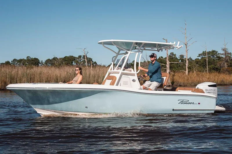 Slide: The Image of Manufacturer Provided Image: 2025 Pioneer 222 Islander boat cruising on a calm river with two passengers. - 2