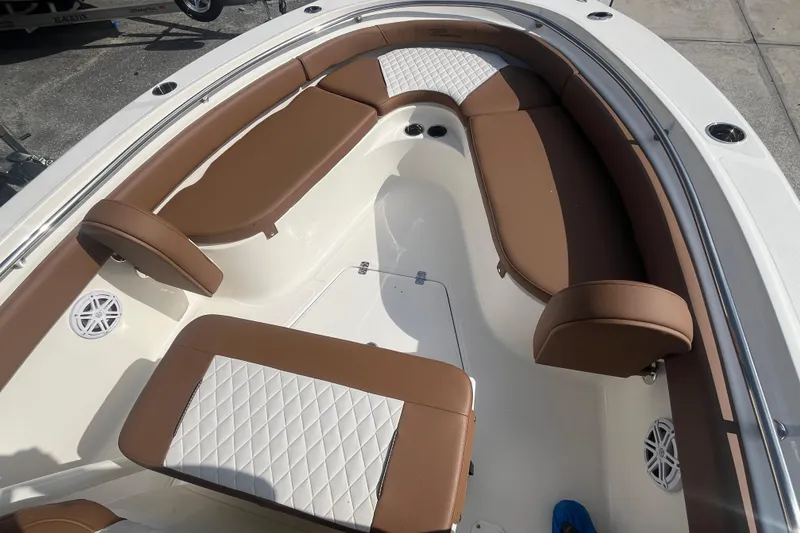 Slide: The Image of 2026 Pioneer 222 Islander boat interior with brown and white cushioned seating. - 20