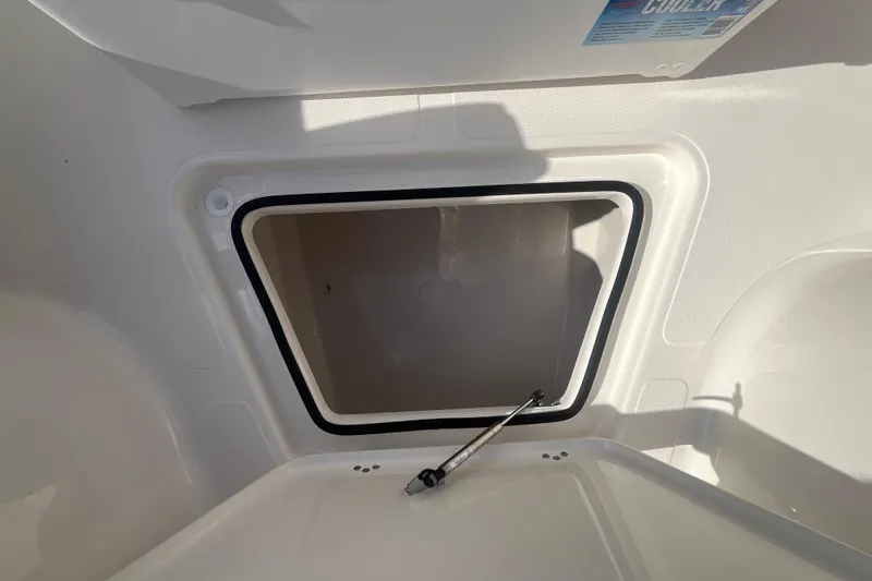 Slide: The Image of Storage compartment of 2026 Pioneer 222 Islander boat, featuring a secure latch mechanism. - 23