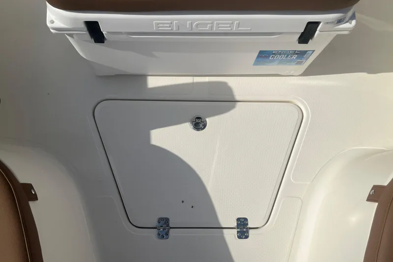 Slide: The Image of 2026 Pioneer 222 Islander boat interior with Engel cooler and storage compartment. - 25