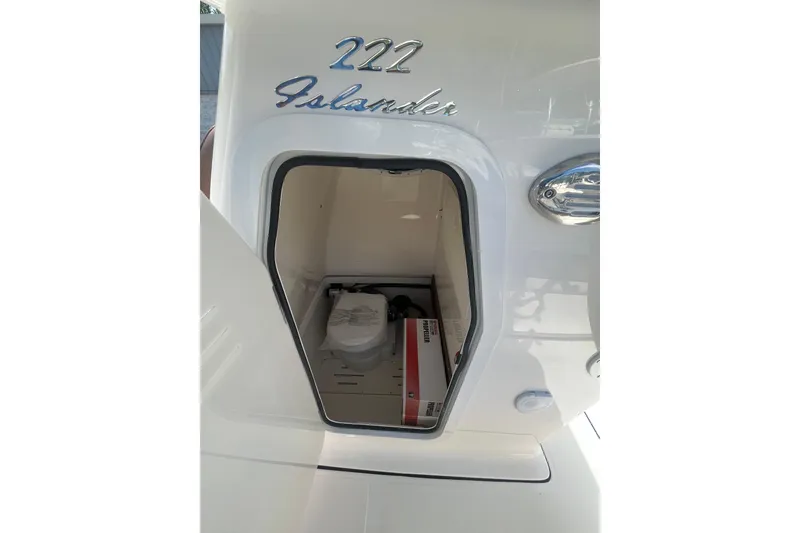 Slide: The Image of 2026 Pioneer 222 Islander boat storage compartment with visible equipment inside. - 33