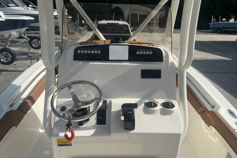 Slide: The Image of 2026 Pioneer 222 Islander boat dashboard with steering wheel and controls. - 36
