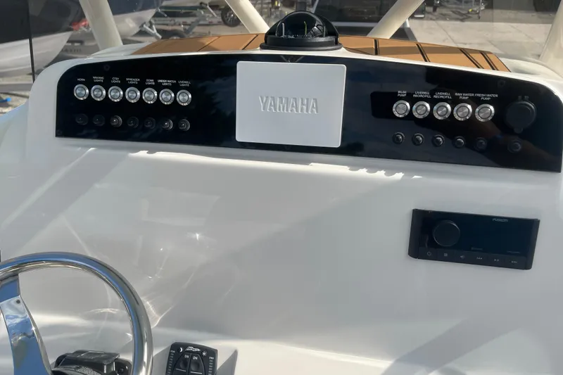 Slide: The Image of Control panel of 2026 Pioneer 222 Islander boat with Yamaha branding and various switches. - 45