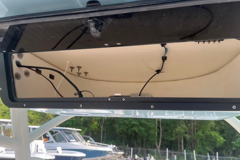 Slide: The Image of Open electronics compartment of 2026 Pioneer 222 Islander boat, showing wiring and components. - 46