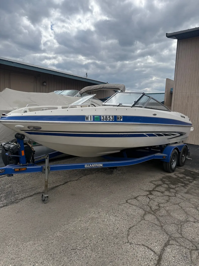 The Image of 2008 Glastron GT 225 boat on trailer, cloudy sky. - 0
