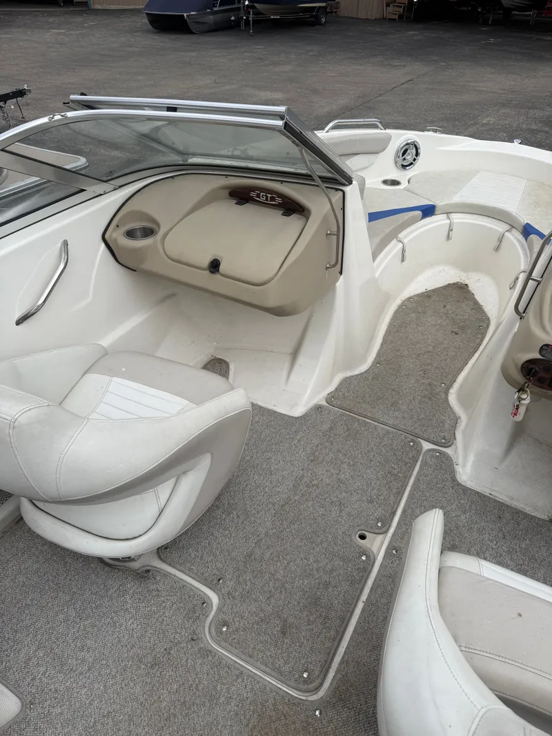 Slide: The Image of Interior of a 2008 Glastron GT 225 boat with white seating. - 3