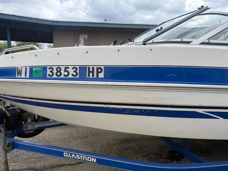 Slide: The Image of 2008 Glastron GT 225 boat with blue stripe and registration number. - 5